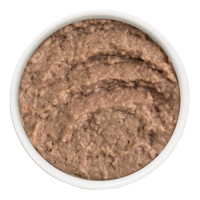 A white bowl filled with creamy, brownish-gray Weruva Press Your Dinner! cat food, seen from above on a white background.